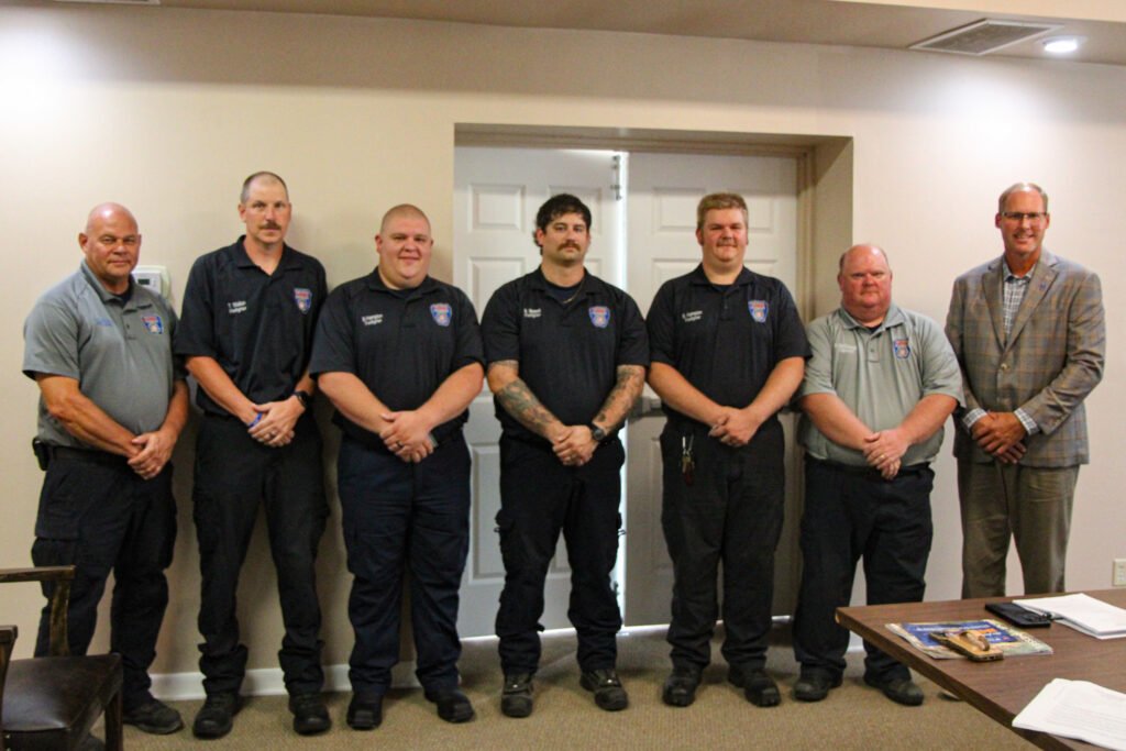 Huntingdon Fire Chief John Fordon, firefighters Tim Walton, Brad Hampton, Brett Hampton, Noah Maxwell, Brian McDowell, and Mayor Chad Edwards pose together after the firefighter swearing-in ceremony.