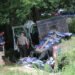 Tennessee Highway Patrol trooper and first responders inspect a wrecked flatbed truck in Carroll County.