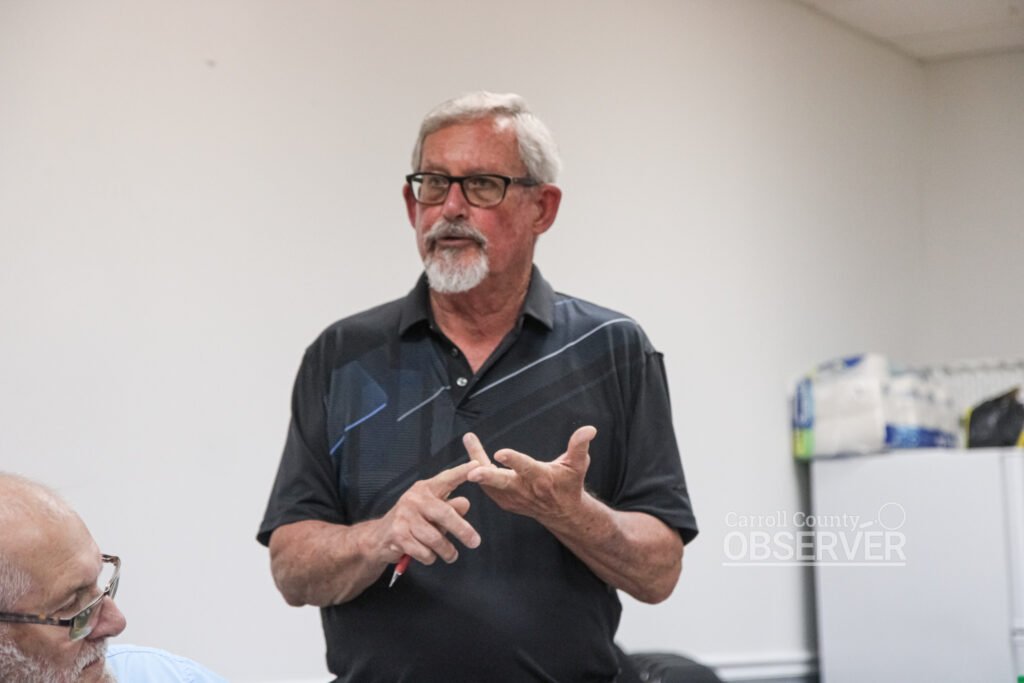 Alderman Don Barger standing and speaking at Trezevant board meeting August 2026 with another board member visible to his left.