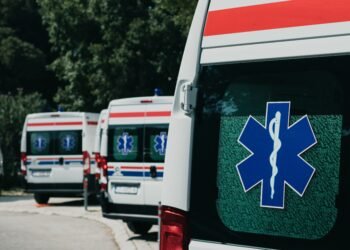 Three ambulances parked outdoors, ready for emergency healthcare situations.