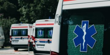 Three ambulances parked outdoors, ready for emergency healthcare situations.